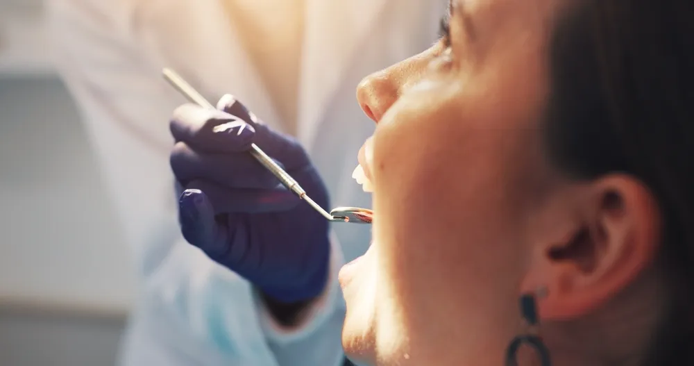 A hygienist examining a patient at Chandler Park Dental Care